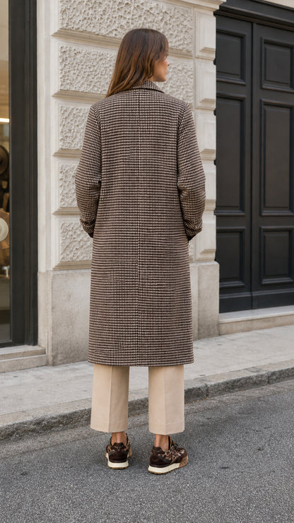 Back view of woman wearing structured brown houndstooth midi overcoat