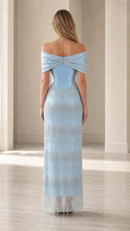 Back view of model in light blue off-the-shoulder formal gown with draped neckline