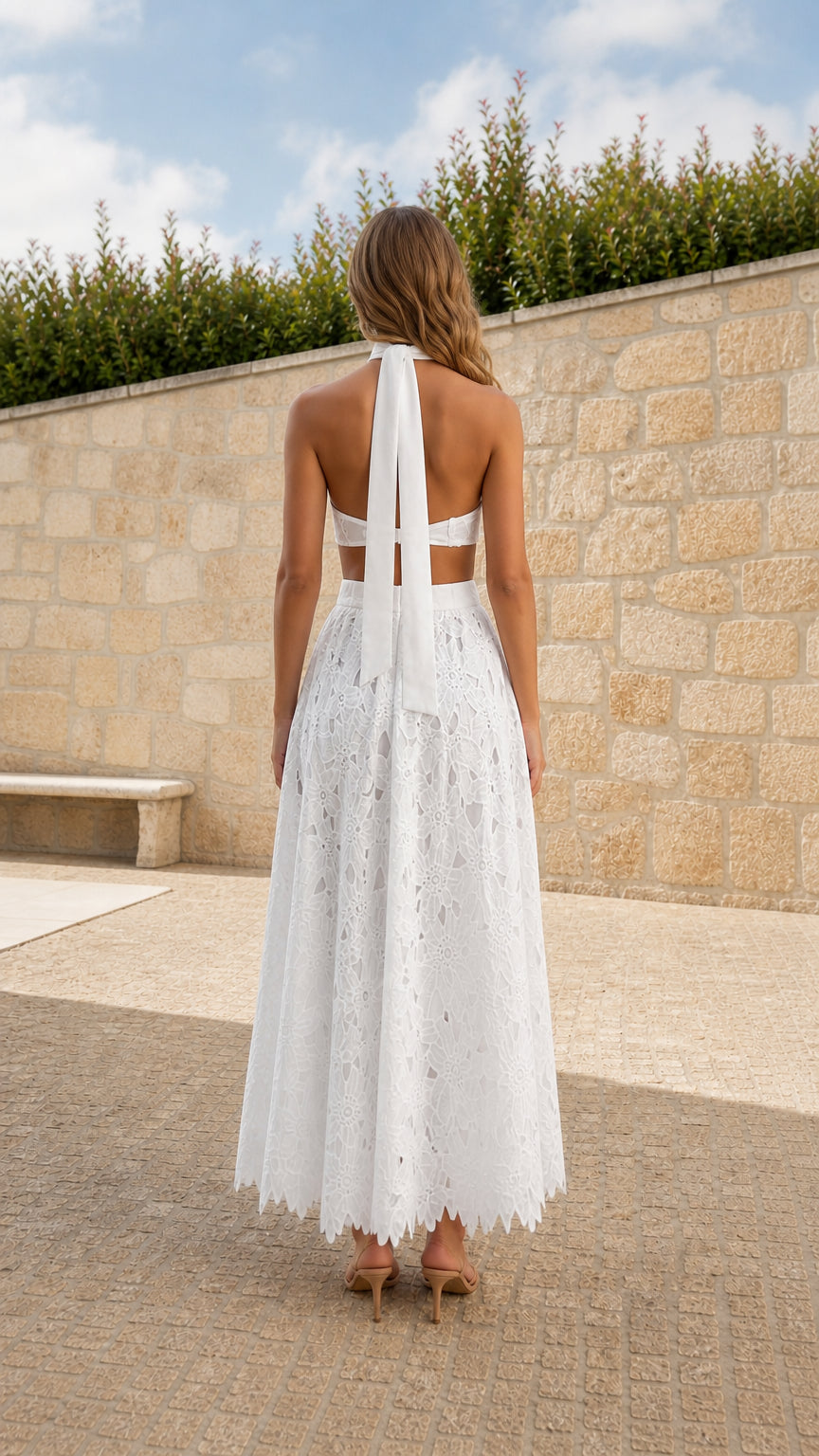 Back view of model showing self-tie bow on White halter lace maxi dress