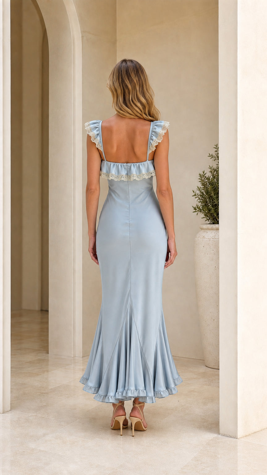 Model wearing light blue ruffle trim maxi dress back view