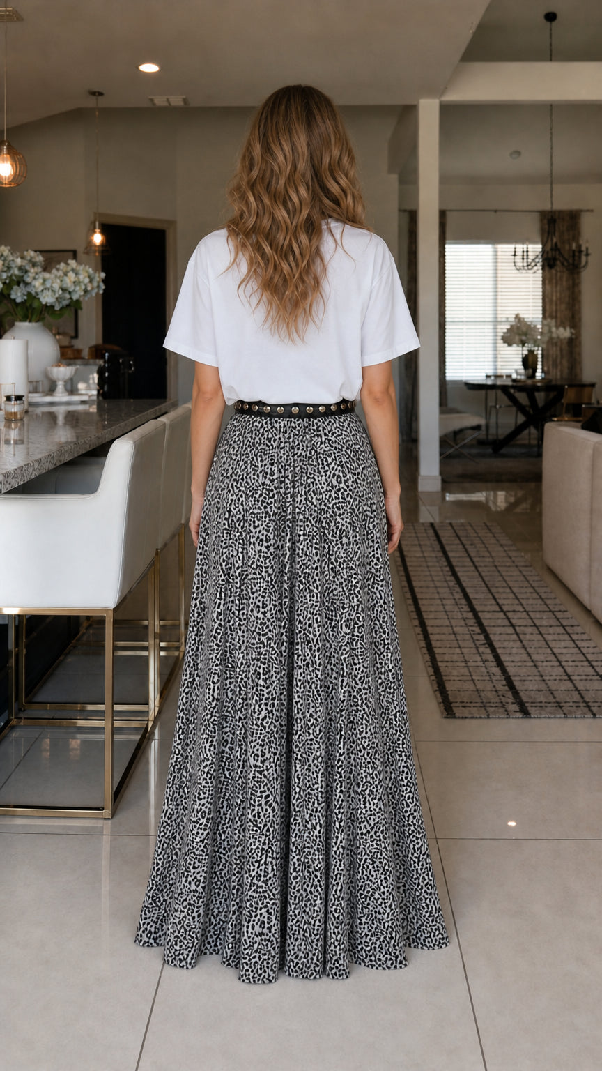 Back view of model in white graphic tee and leopard print pants