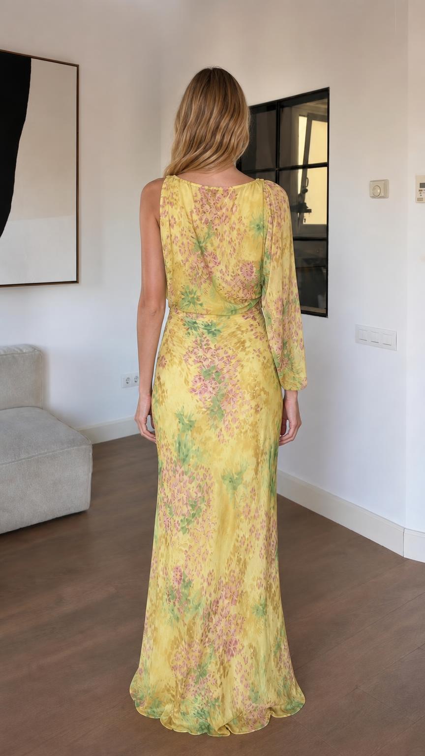 Back view of woman in yellow floral one-sleeve dress