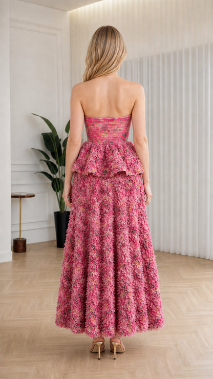 Back view of model in pink strapless ruffle maxi dress