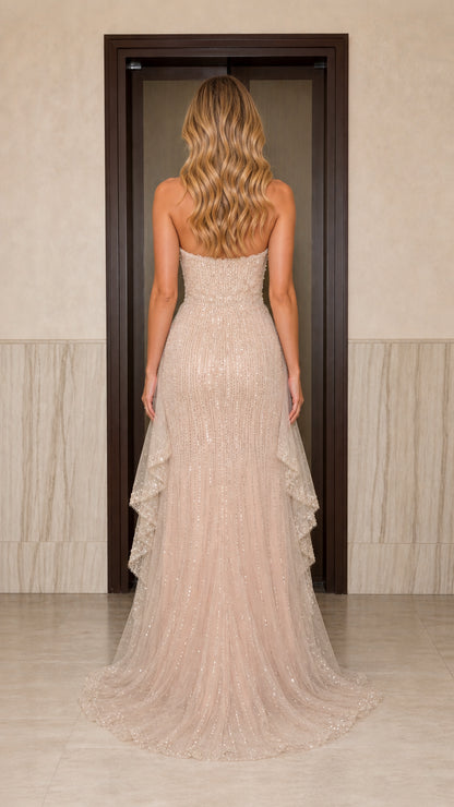 Back view of champagne sequin formal dress showing train