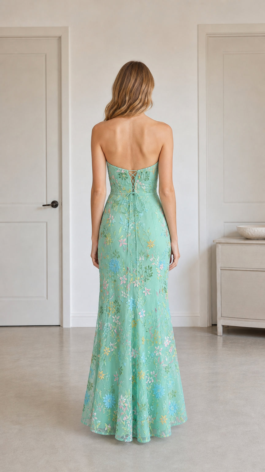 Back view of mint green dress highlighting corset lace-up detail