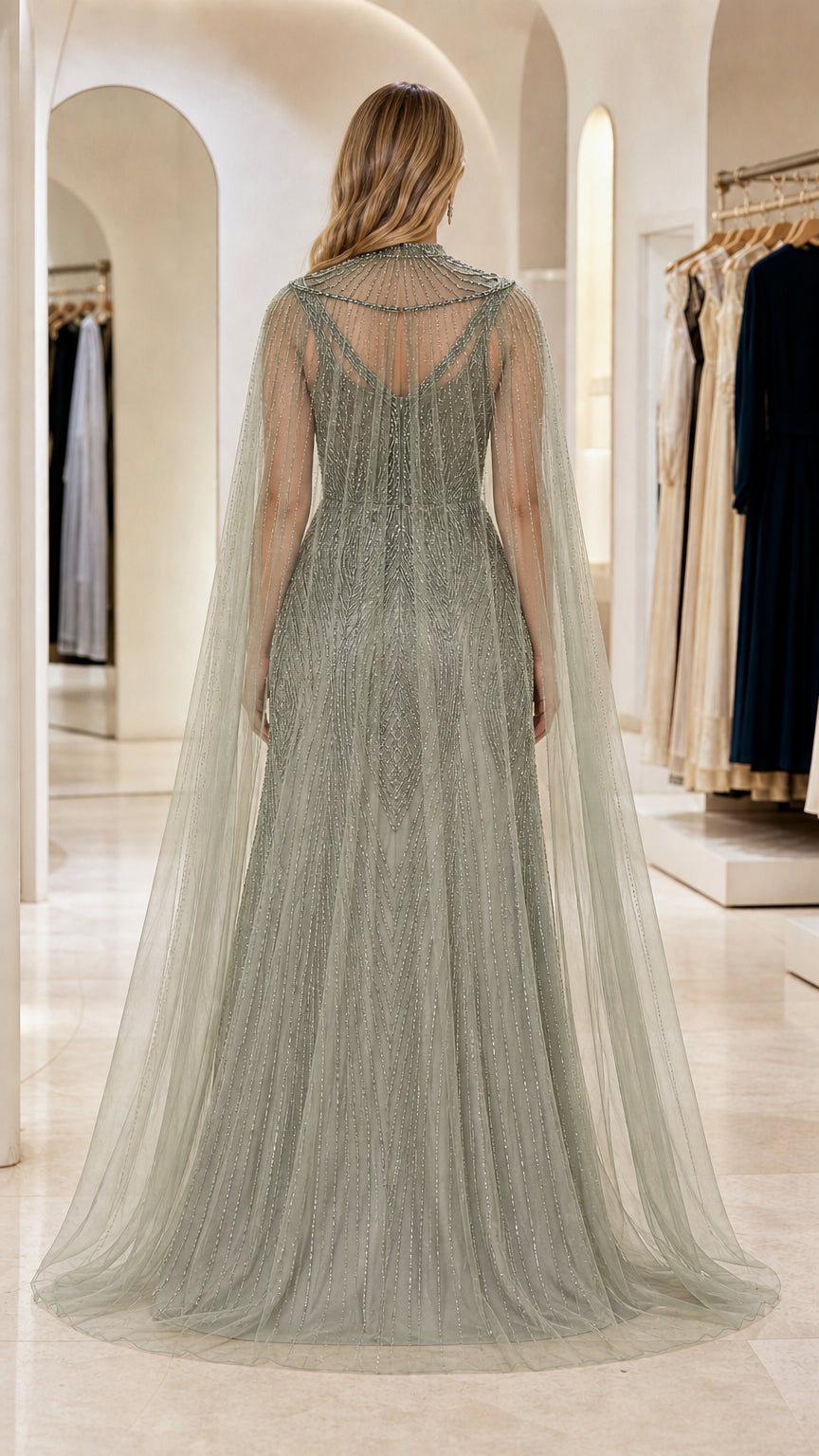 Back view of Sage Green beaded cape gown showcasing delicate sheer tulle drape