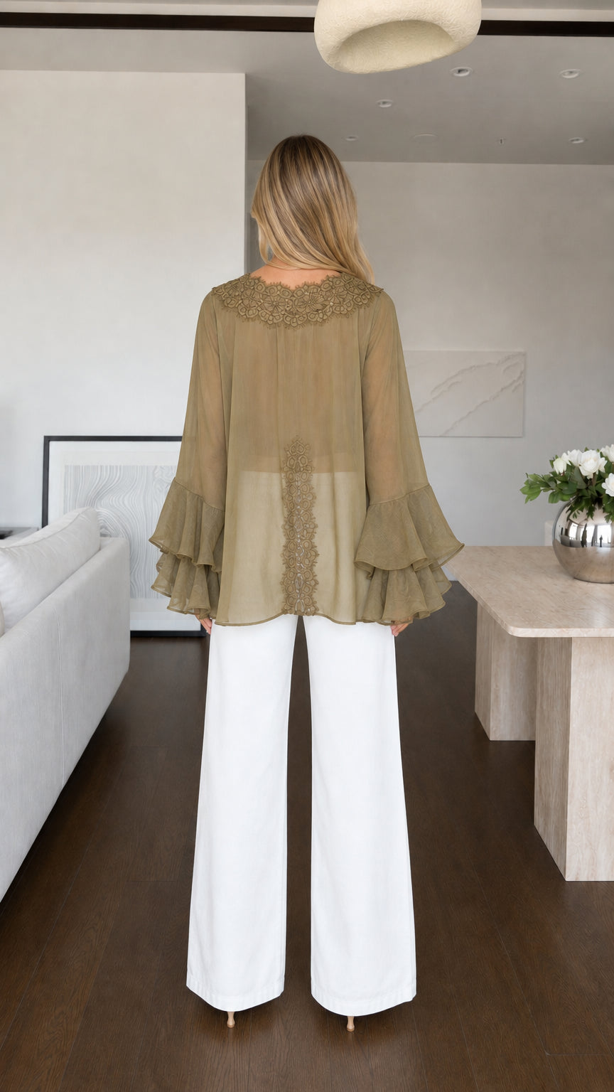 Model wearing olive blouse back view