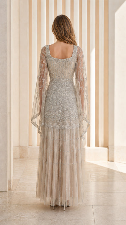 Champagne floor-length formal gown back view with sheer draped sleeves