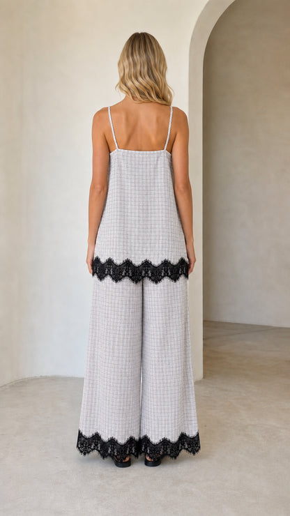 Model wearing white plaid two-piece set, back view