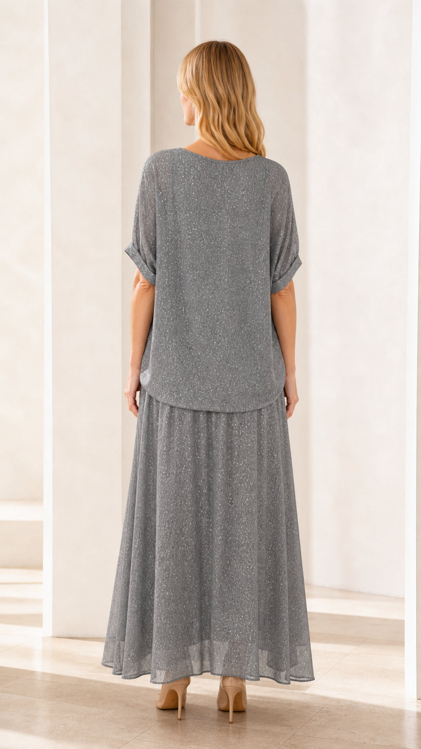 Back view of model in grey shimmer two-piece outfit