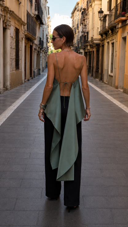 Back view of sage green open-back cami top with tie detail and asymmetric drape