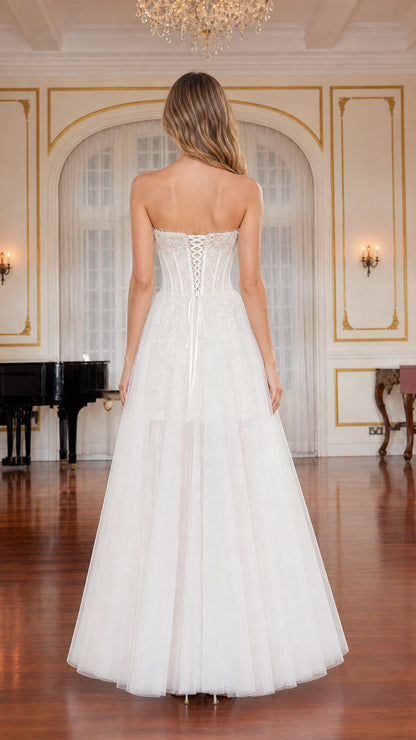 Back view of white gown highlighting adjustable lace-up corset back