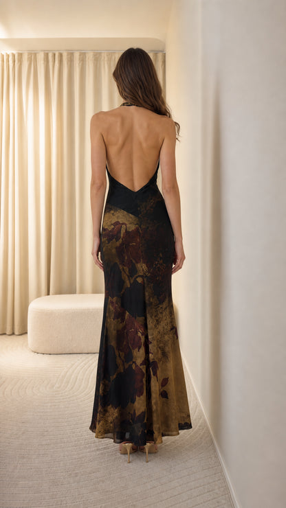 Back view showing open back of black maxi dress