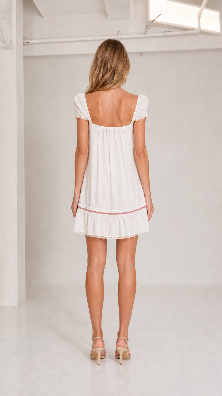 Back view of white square back babydoll mini dress