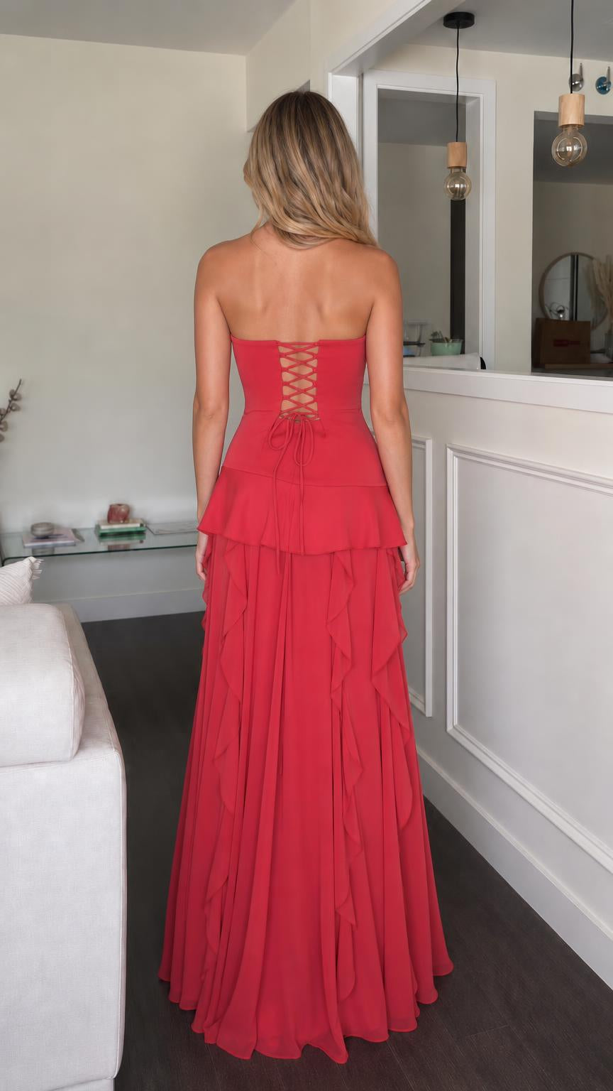 Back view of red strapless maxi dress showing lace-up detail