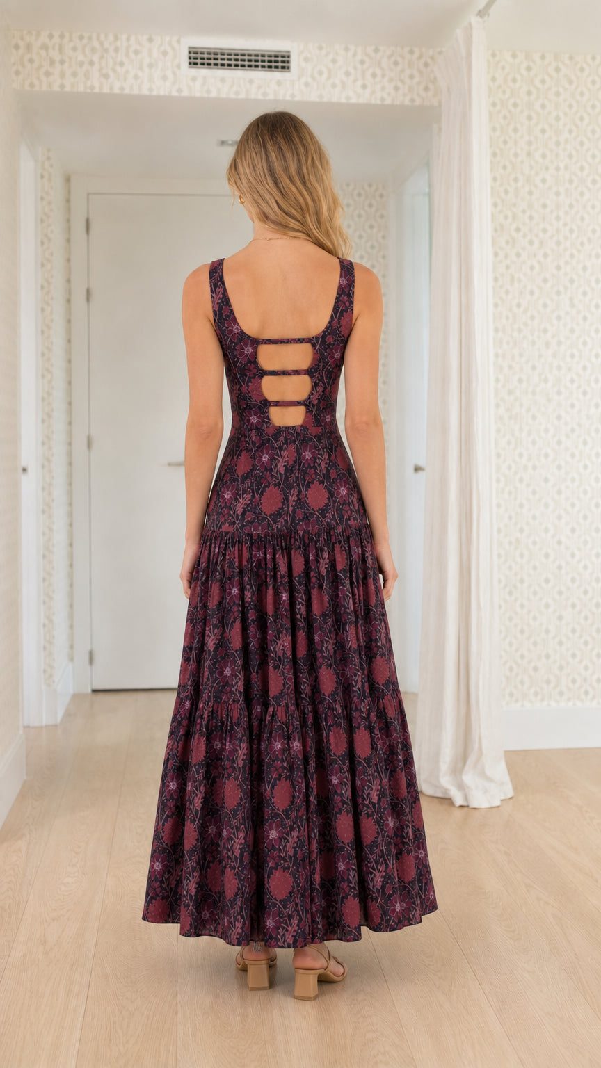 Back view showcasing cutout ladder back detail on plum floral maxi dress