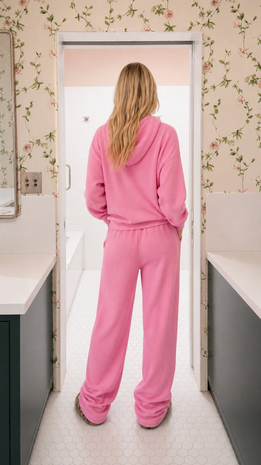 Back view of model wearing pink hooded sweatshirt and wide-leg knit lounge pants