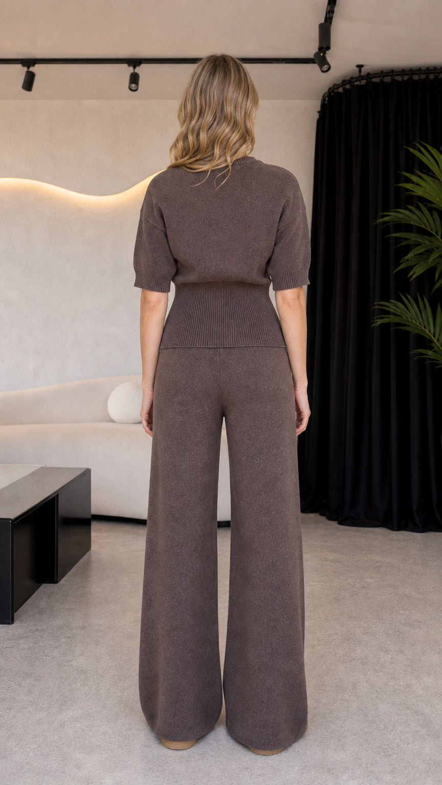 Back view of model wearing taupe knit top and wide leg knit trousers