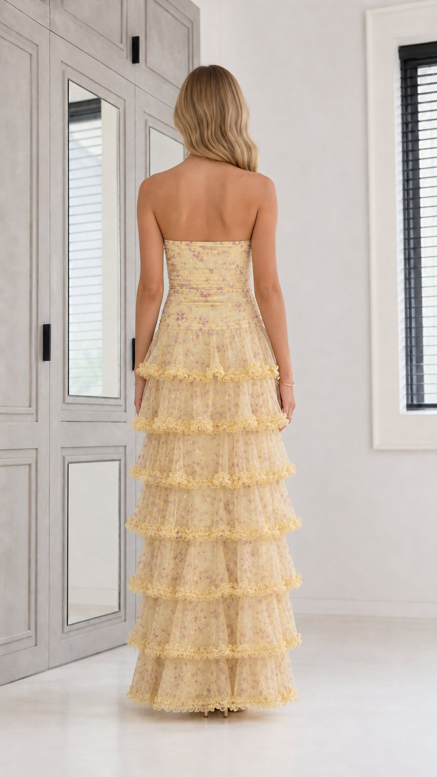 Back view of yellow strapless tiered floral maxi dress