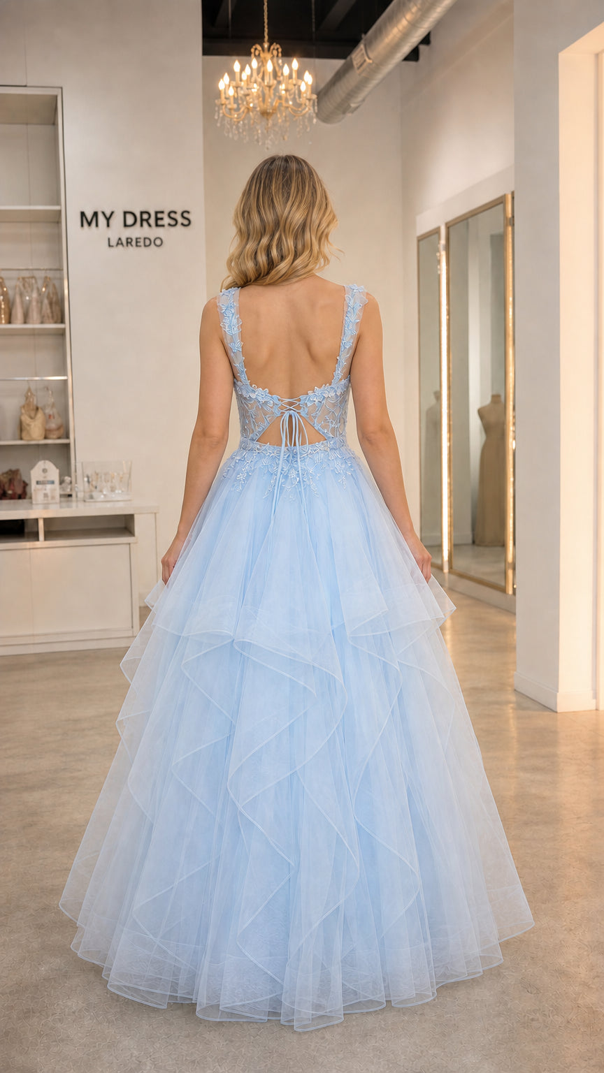 Back view showing lace-up details of light blue ball gown