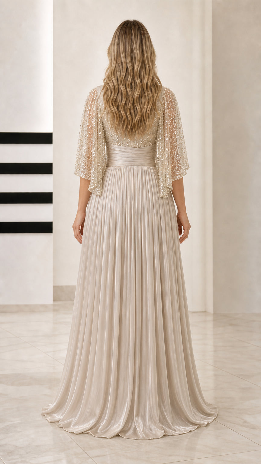 Back view of Champagne pleated evening dress with flutter sleeves