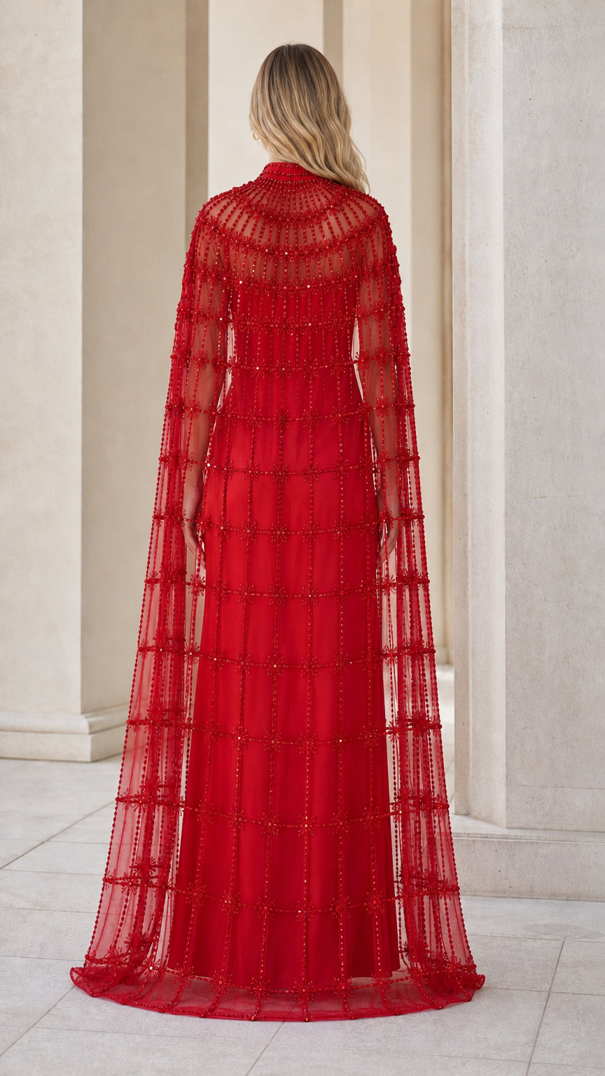 Back view of model showcasing flowing red beaded cape