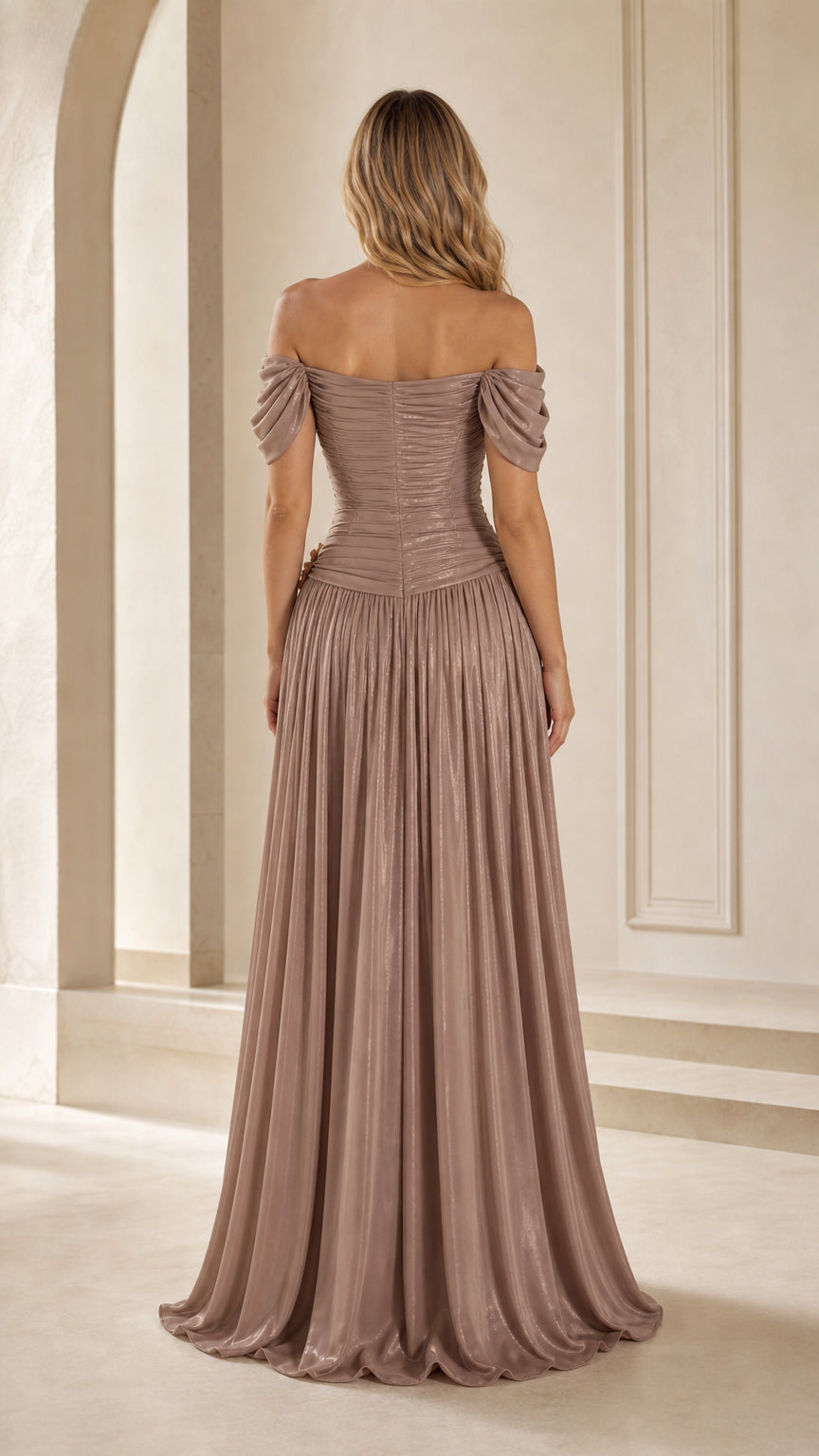 Back view of taupe off-the-shoulder evening gown showcasing pleated skirt