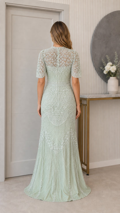 Back full-length view of sage green beaded illusion back evening gown