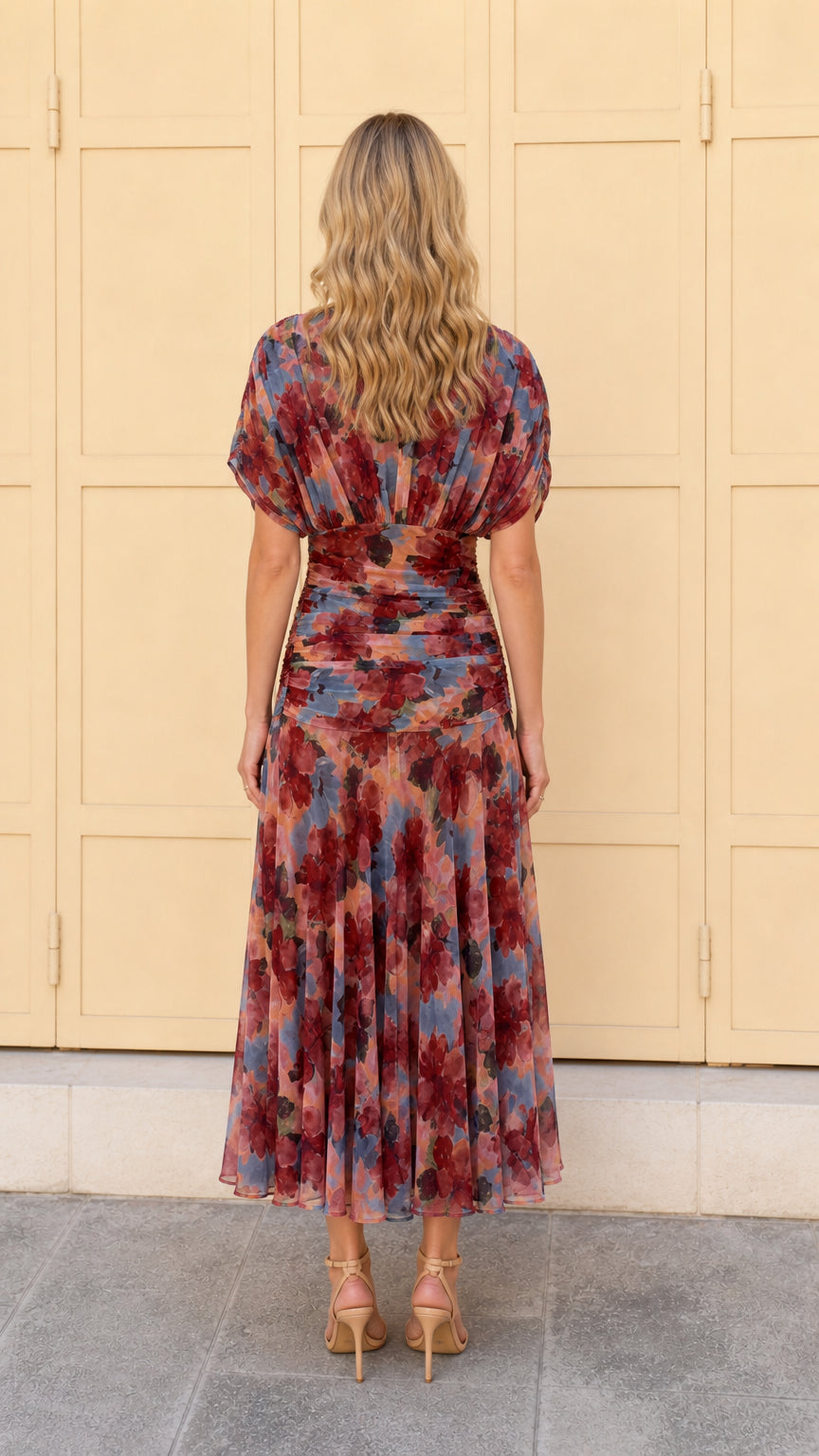 Back view of woman wearing multi pink floral ruched midi dress