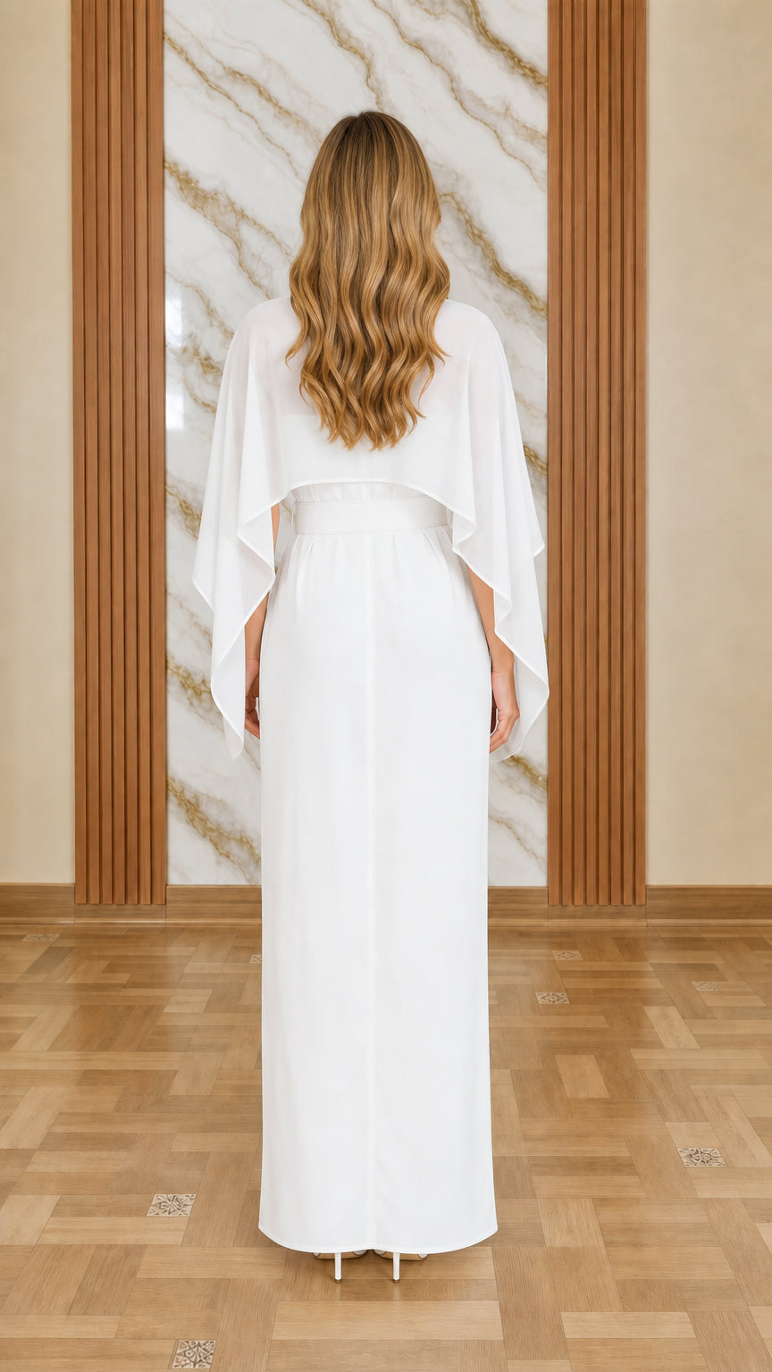 Back view of model in white cape jumpsuit
