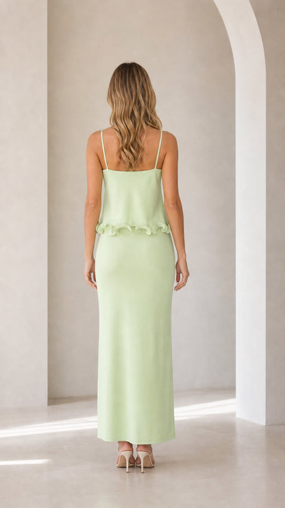 Back view of model in sage green maxi dress