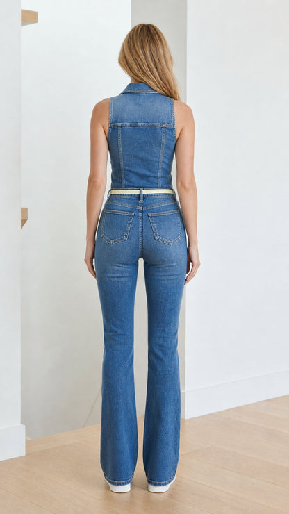 Back view of model wearing blue denim flare jumpsuit