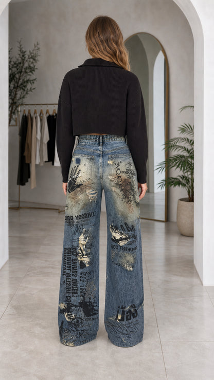 Back view of woman wearing distressed graphic wide-leg jeans showing back pockets