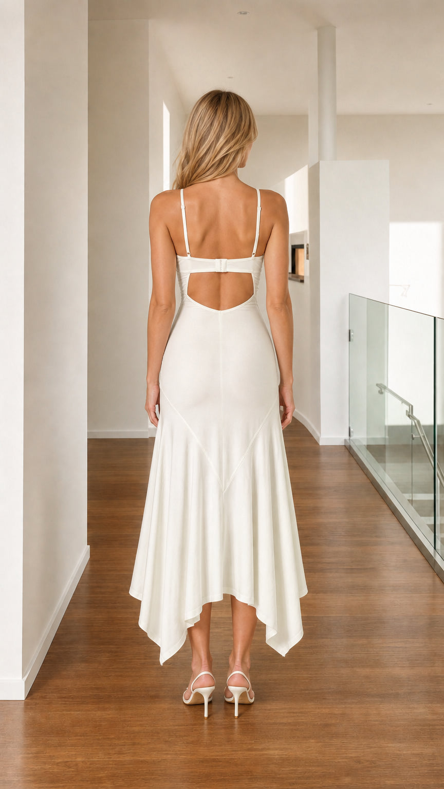 Back view of woman wearing white dress with cutout back