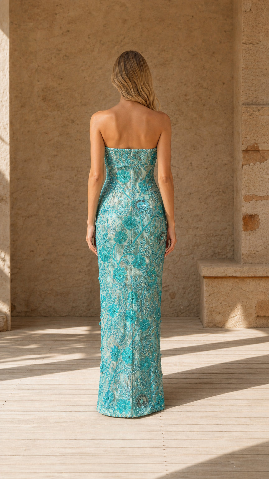 Back view of model wearing Aqua Blue strapless sequin column gown