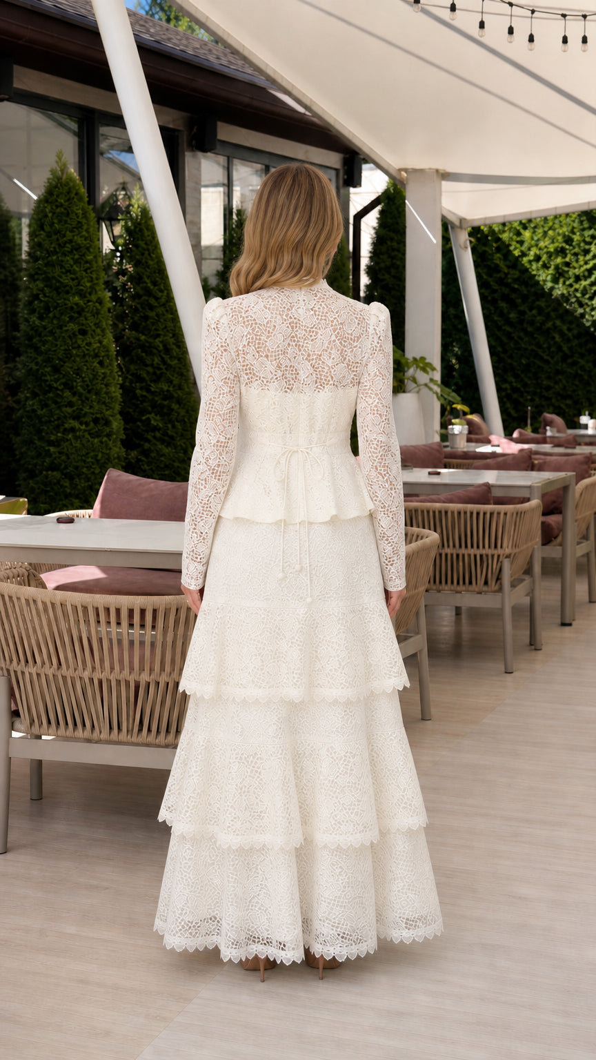 Back view of woman wearing ivory floral lace long-sleeve maxi dress
