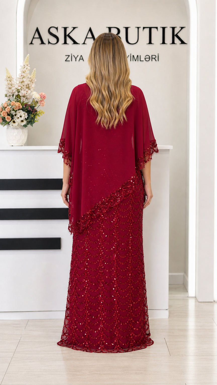 Back view of burgundy formal dress with flowing chiffon overlay