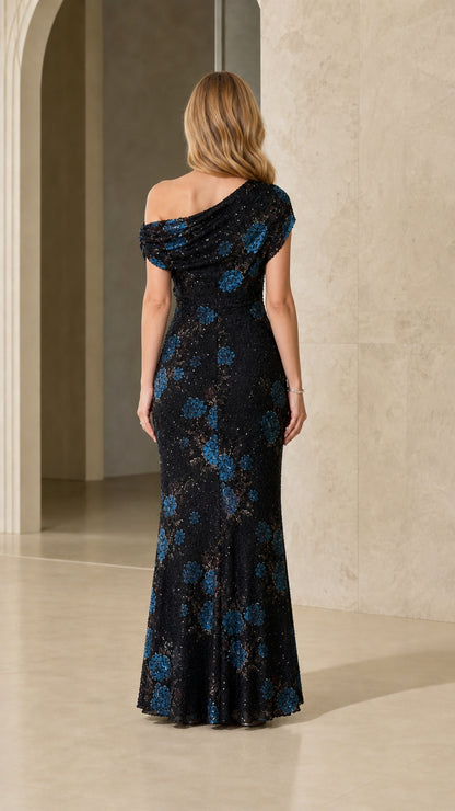 Back view of model in black sequin floral maxi dress