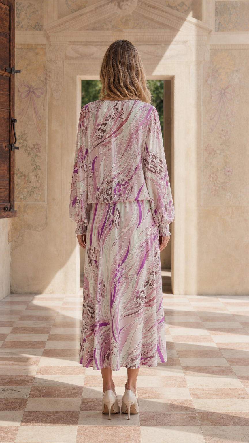 Back view of model in pink abstract maxi dress
