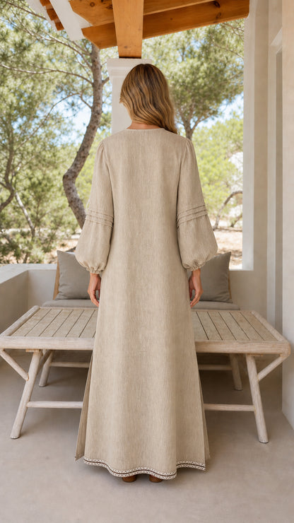 Back view of woman wearing beige long sleeve maxi dress