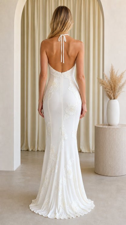 Back view of Ivory White backless halterneck evening gown with flared hem
