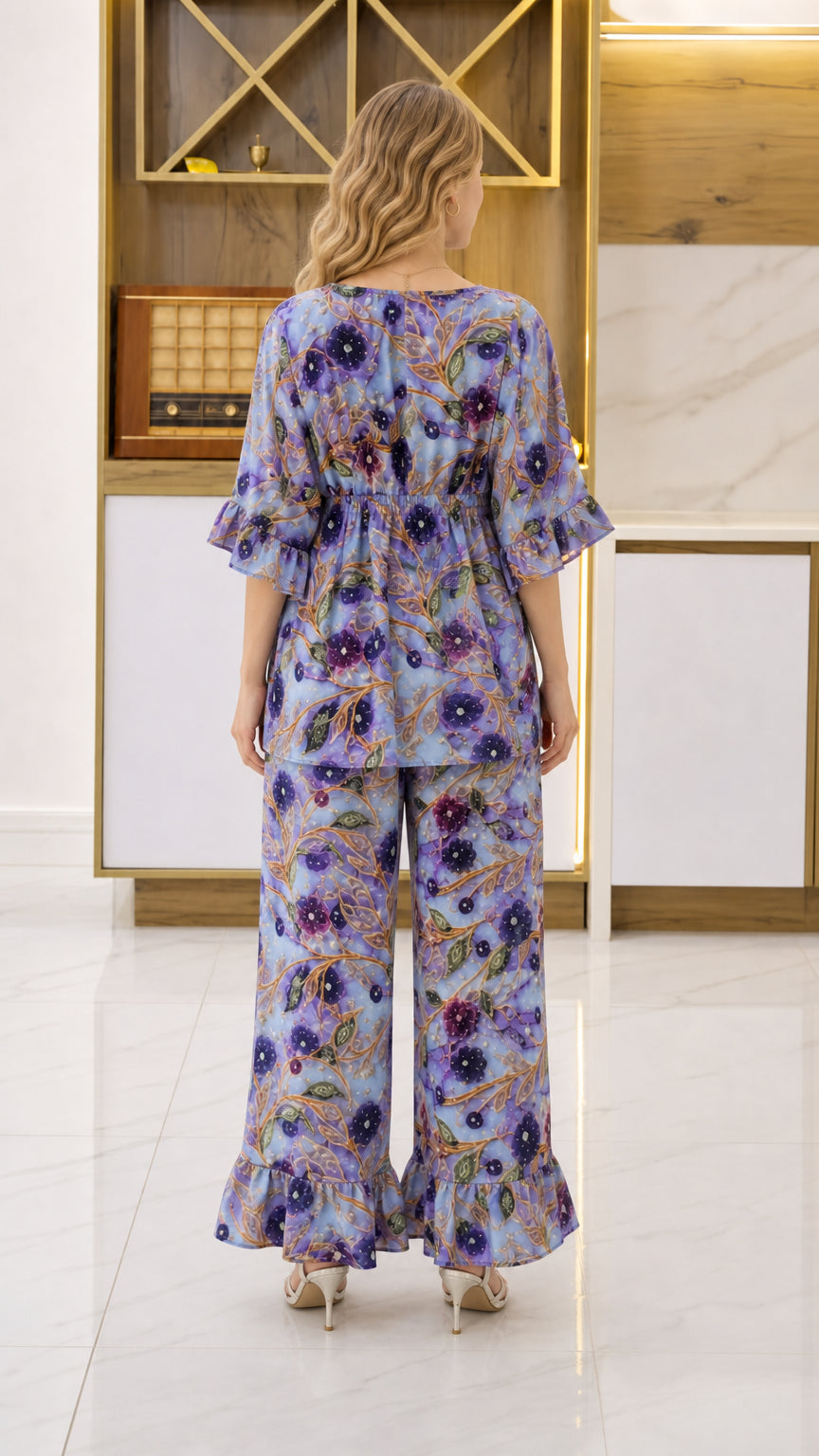 Back view of woman wearing Periwinkle Blue floral 2-piece set with ruffled cuffs
