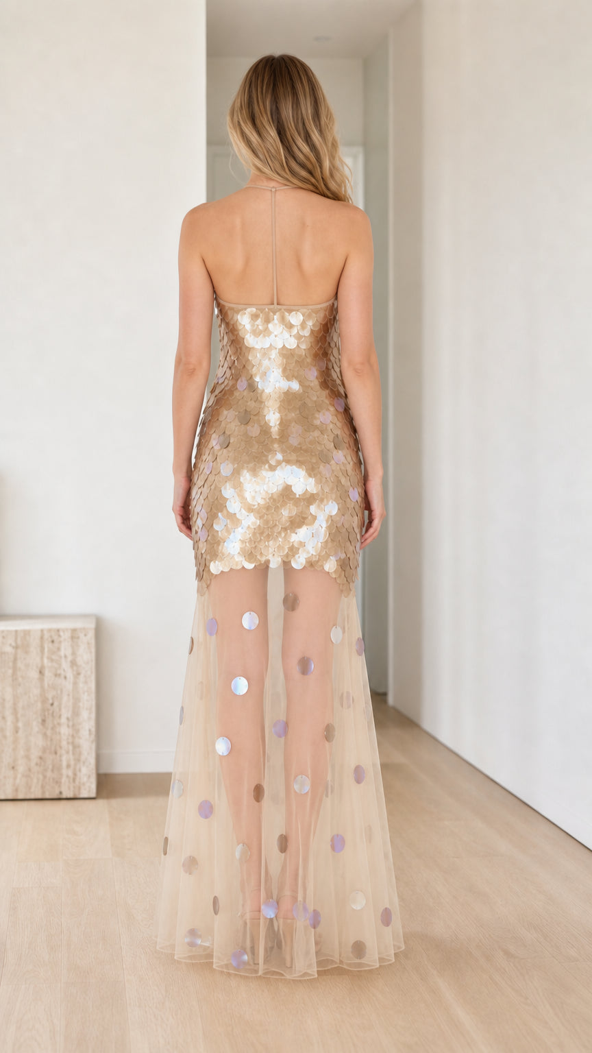 Back view of model in Gold sequin maxi dress