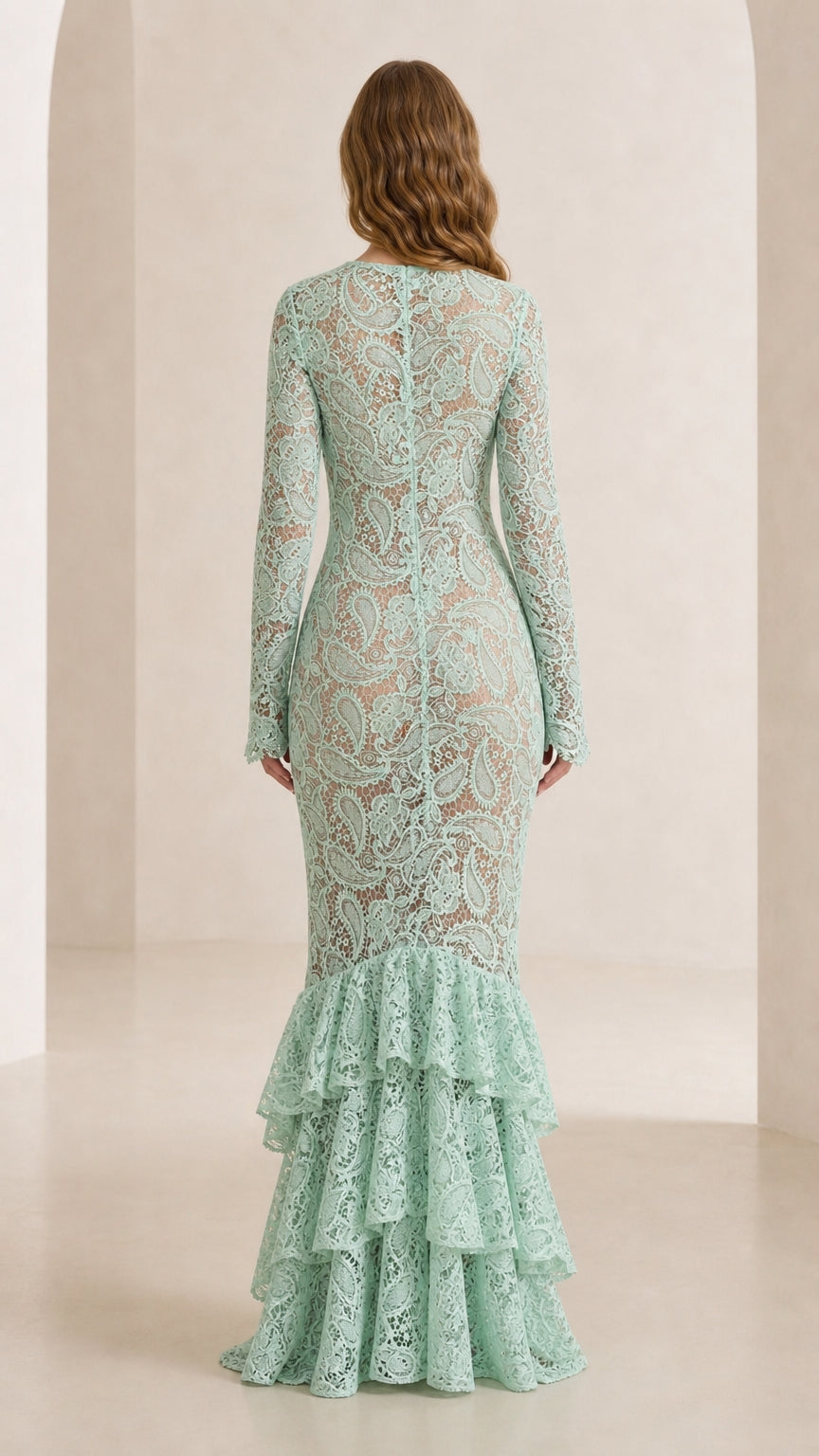 Back view of model showing tiered hem of mint green lace dress