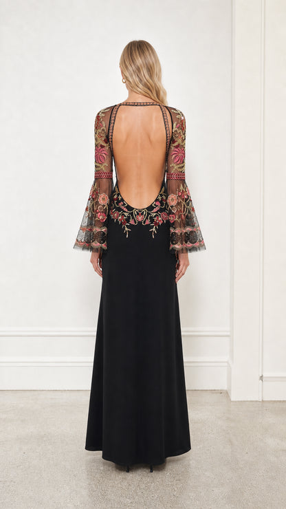 Back view showing open back design of the black maxi dress