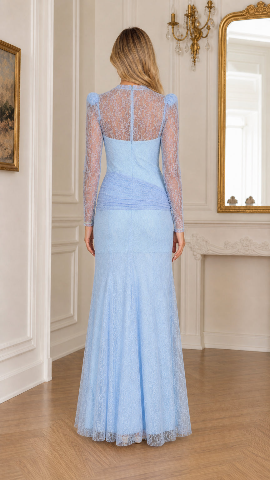 Back view of a woman in a light blue lace evening gown showing sheer illusion back and floor-sweeping hem