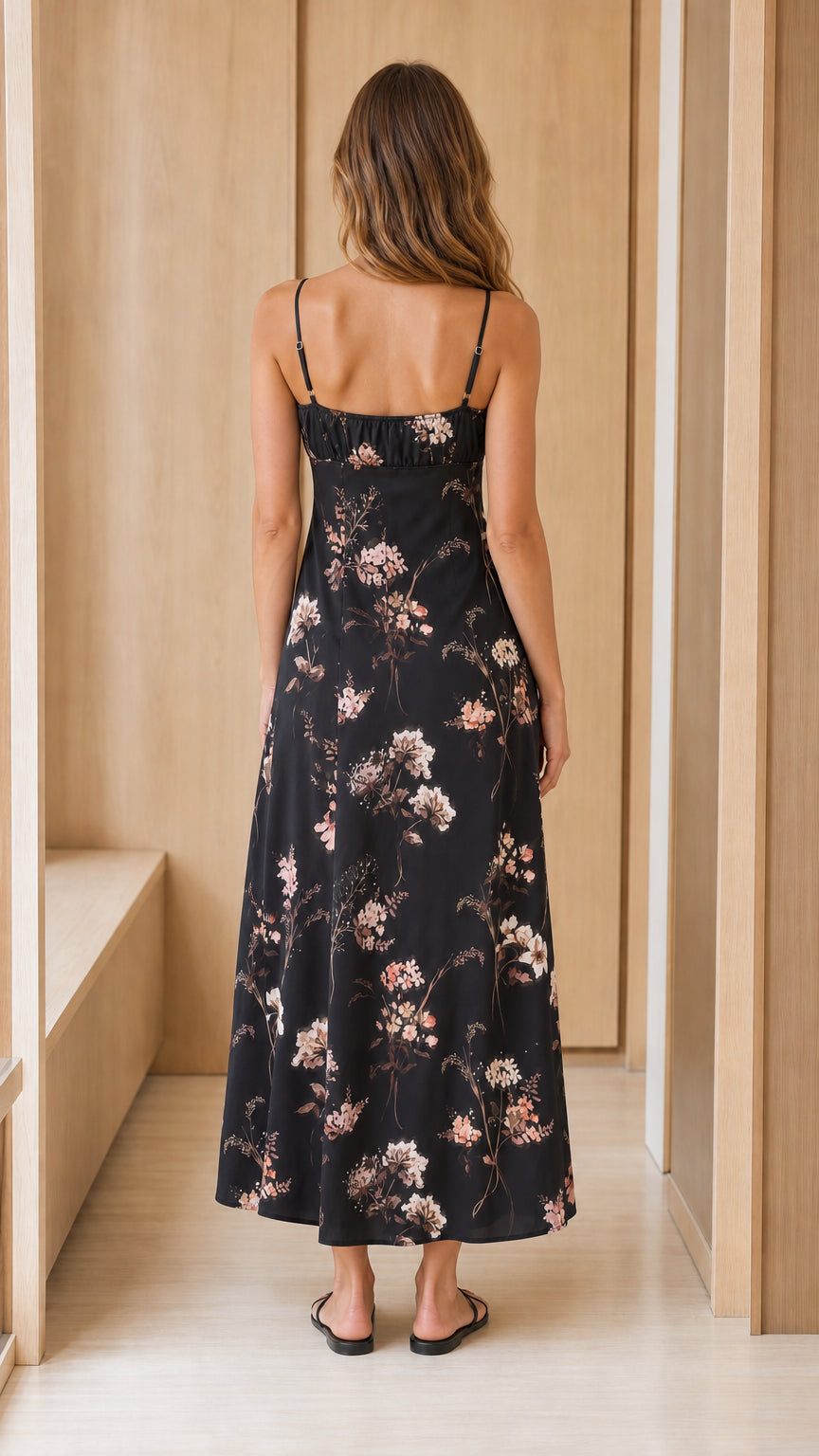 Back view of woman wearing black floral midi dress
