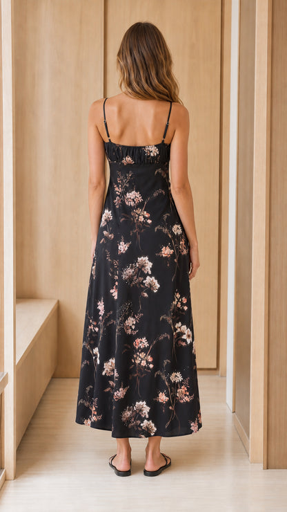 Back view of woman wearing black floral midi dress