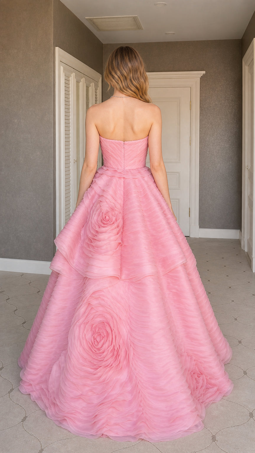 Back view of model in pink ruffled formal dress