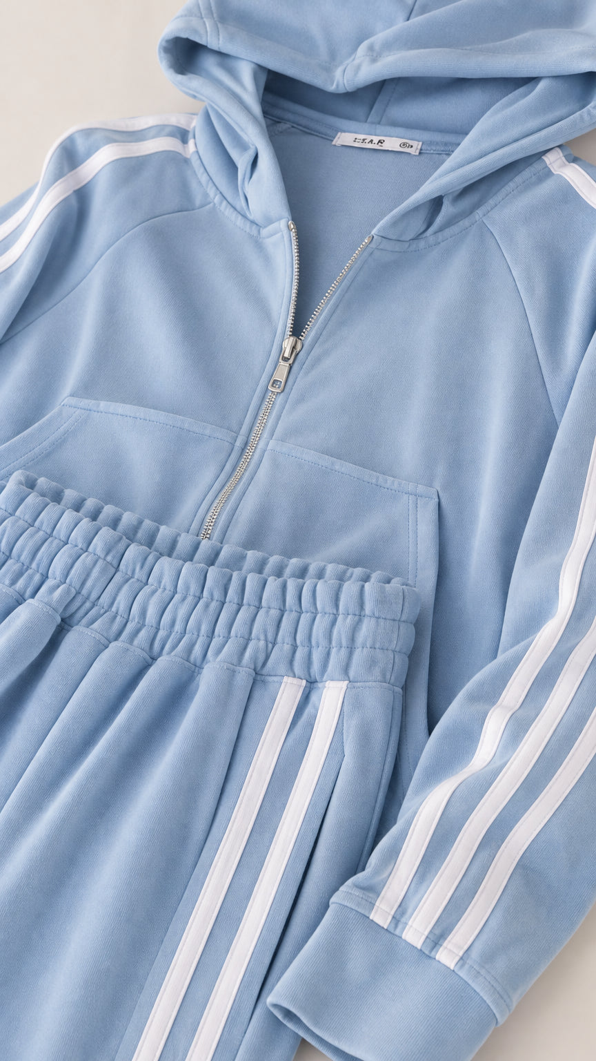 Close-up detail of Light Blue cropped zip hoodie neckline, zipper, and striped sleeve finish